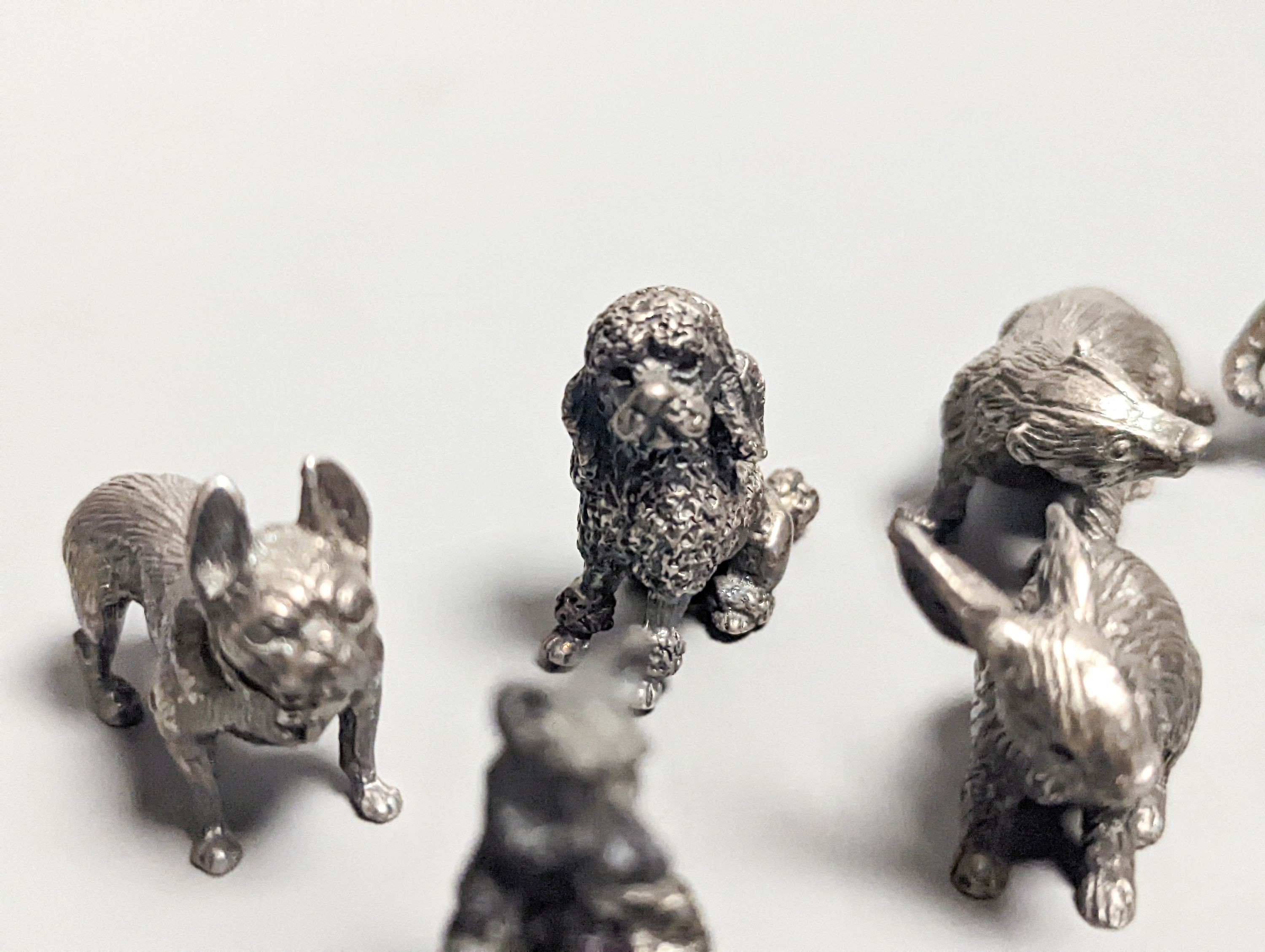 Four modern miniature freestanding model animals, including, badger, two dogs and a cat, JJSM, London, 1989 &1991, cat length 37mm, two Italian 925 models and two base metal models.